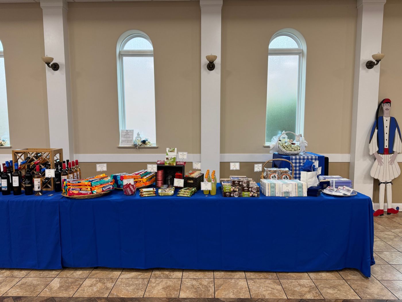 Greek wine, chocolates, halva, and gift boxes on the market table
